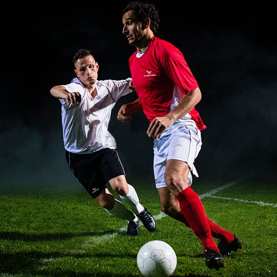 Football players competing for the ball during a match