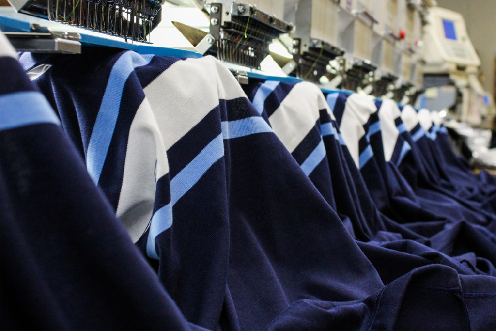 Shirts going through the embroidery process