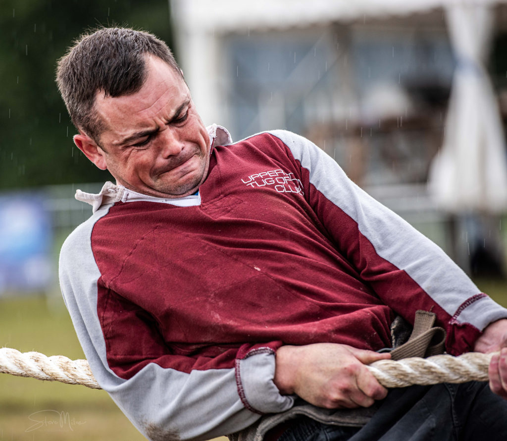 Athlete wearing maroon custom tug of war top during competition