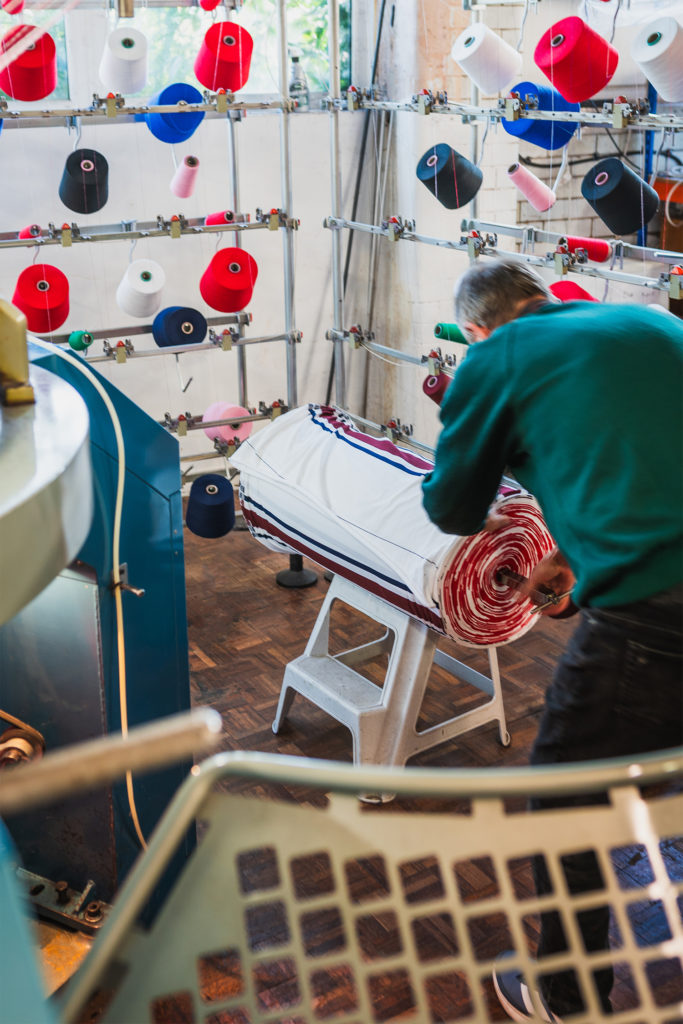 Freshly knitted rugby shirt fabric coming off a circular knitting machine.