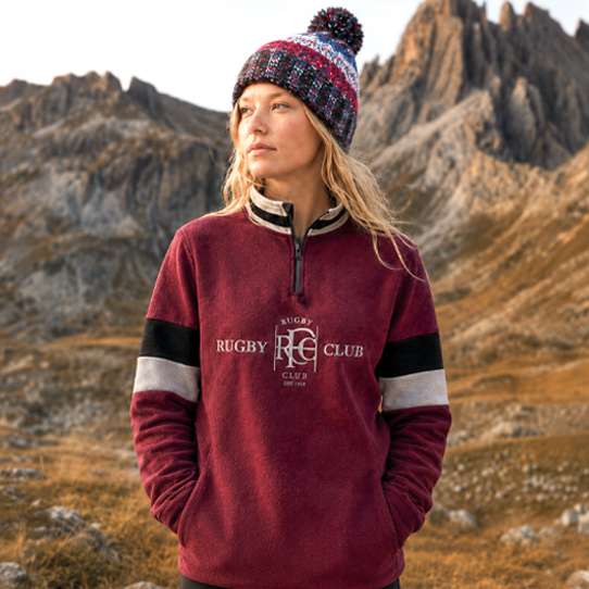 Woman wearing a burgundy retro quarter zip rugby fleece outdoors